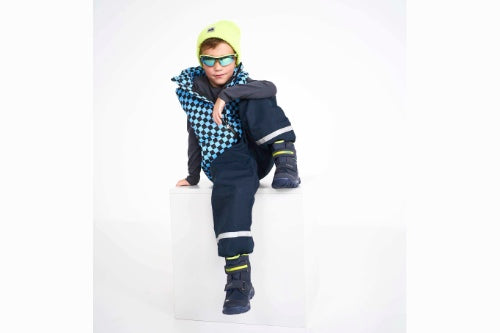 boy sitting on a white background wearing blue boots